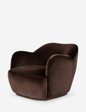 Angled view of the Selkie modern barrel swivel chair in brown velvet.