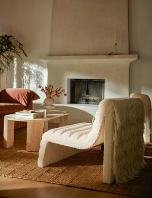 Leon textural boucle channel tufted armless accent chair by Carly Cushnie styled with an oval stone coffee table.