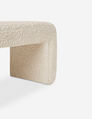 Close-up of the side and inner wall of the Mikhail cream boucle foam-padded bench.