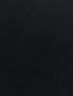 Close up of the wood grain of the Mojave round dining table in black.