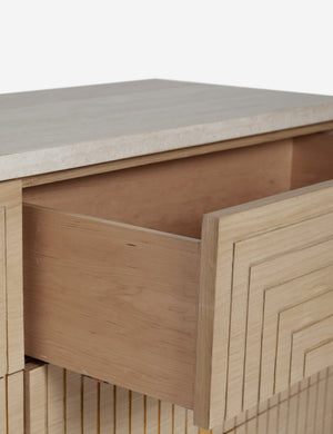 Close up of the open top drawer of the Rayner carved linear detailing oak six drawer dresser.