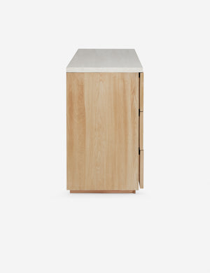 Side profile of the Rayner carved linear detailing oak six drawer dresser.