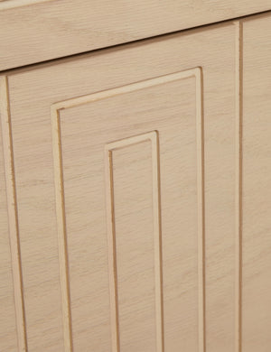 Close up of the Rayner carved linear detailing oak two drawer nightstand.