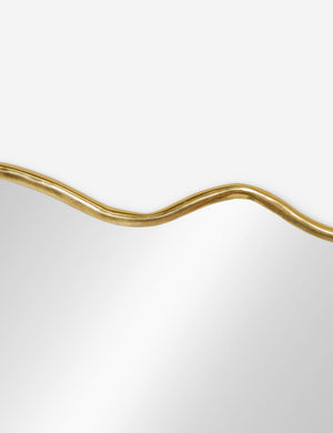 The wavy silhouette on the top of the rook mantel mirror
