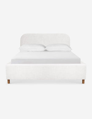 Solene White linen platform bed with an arched headboard and oak wood legs