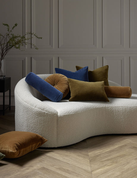 #color::olive #style::lumbar #color::olive #style::square  #fill type::with-feather-down-insert  #fill type::pillow-cover-only |   Charlotte velvet pillow in toast, olive, and true blue sit on a cream boucle lounger with other velvet pillows