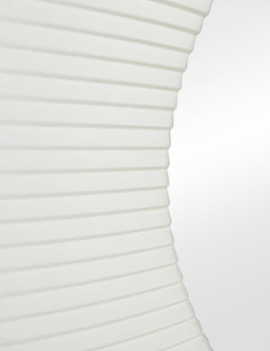 Close up of the Whitaker white asymmetrical oval wall mirror.