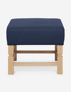 Ambleside Dark Blue linen upholstered ottoman by Ginny Macdonald with a carved frame and vertical channeling on the cushion