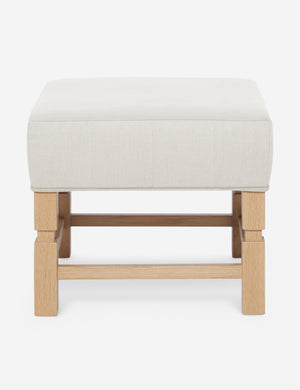 Ambleside Natural linen upholstered ottoman by Ginny Macdonald with a carved frame and vertical channeling on the cushion