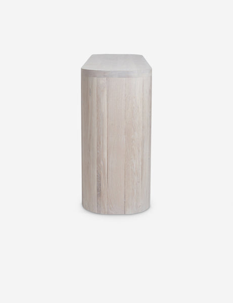 #color::washed-oak | Side view of the Luna white-washed oak oval console table.