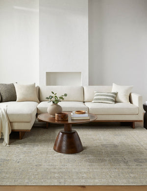  Altin traditional motify wool rug in gray styled in a living room with sofa and coffee table