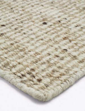 Corner of the Taos neutral light brown wool blend area rug.