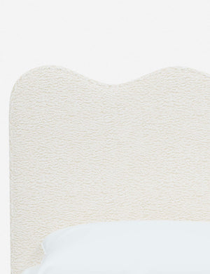 Close-up of the undulating lines on the headboard of the Clementine cream sherpa platform bed