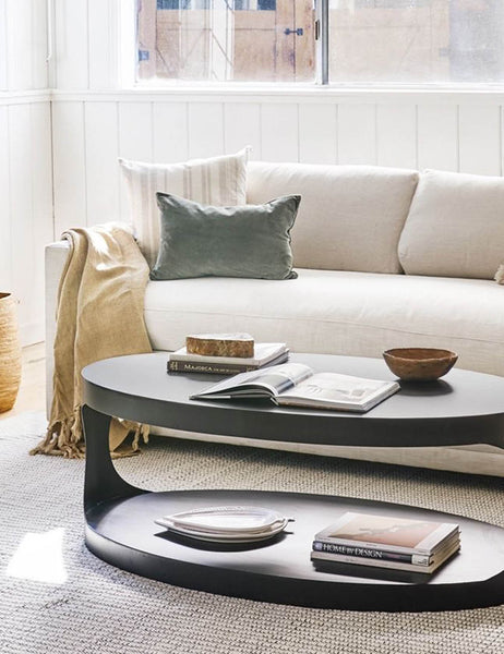 #color::moss #style::lumbar  #fill type::with-feather-down-insert  #fill type::pillow-cover-only |   Charlotte moss green velvet lumbar pillow sits on a cream couch next to an oval coffee table