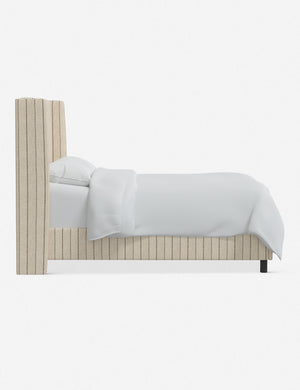 Side view of the Adara natural stripe linen upholstered bed.
