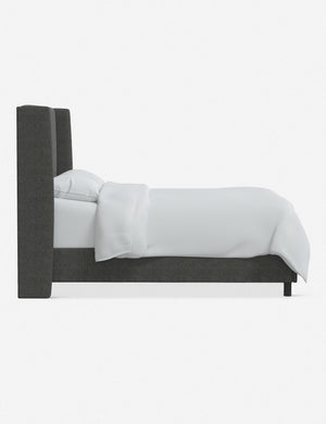 Side view of the Adara gray linen upholstered bed.