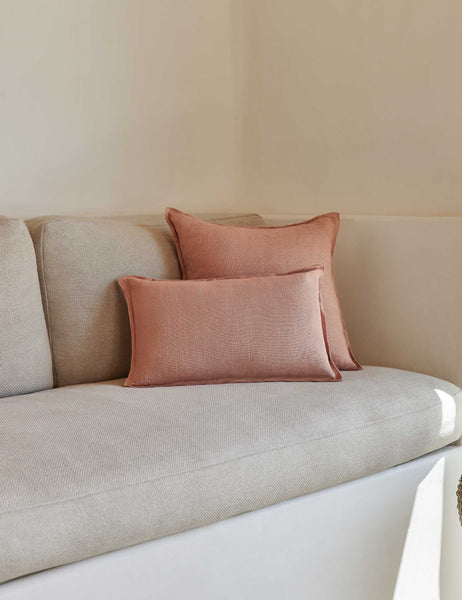 #color::terracotta #style::lumbar #fill type::with-feather-down-insert #fill type::pillow-cover-only | The arlo Terracotta flax linen pillow in its lumber and square sizes sit together on a natural linen sofa