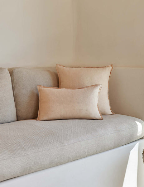 #color::blush #style::lumbar #fill type::with-feather-down-insert #fill type::pillow-cover-only | The arlo Blush pink flax linen pillow in its lumber and square sizes sit together on a natural linen sofa