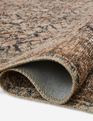Close up of the Billie Rug in ink and salmon by Amber Lewis x Loloi folded over itself