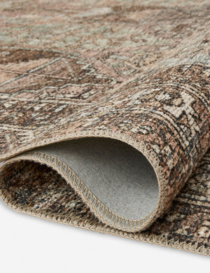 Close up of the Billie Rug in clay and sage by Amber Lewis x Loloi folded over itself