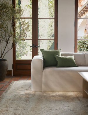 The arlo Olive green flax linen pillow in its lumber and square sizes sit together on a natural linen sofa
