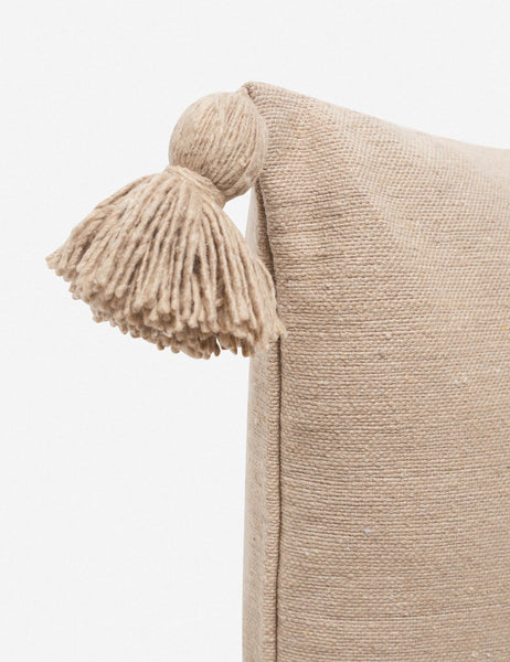 #color::terracotta #size::20--x-20- #size::12--x-24- | Close-up of the pom pom on the corner of the Sami terracotta square pillow