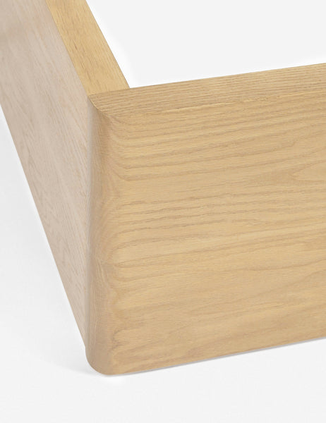 #size::king #size::queen #color::mushroom #size::cal-king | The corner of the wooden-base on the Nia mushroom brown linen bed 