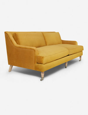 Angled view of the Rivington goldenrod velvet sofa