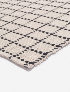 Corner-shot of the Sebou natural and black dotted machine washable mat